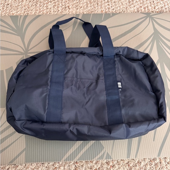 Uniqlo Handbags - Uniqlo Collapsible Bag Navy NWOT